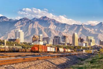 An image of Salt Lake City, Utah, with the skyline visible between a mountain range in the background and a passing train in the foreground. Concept image for ARVO Association for Research in Vision and Ophthalmology. Image credit: ©f11photo – stock.adobe.com