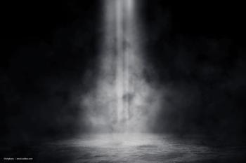 A spotlight shines down onto an empty stage. Image credit: ©Angkana  – stock.adobe.com