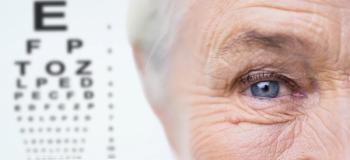 A close-up of an older woman's eye next to a vision chart. Image credit: ©Syda Productions – stock.adobe.com