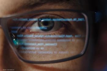 An image of an eye behind glasses. Digital input on the glasses conveys concept of artificial intelligence and computing. Image credit: ©Arsenii – stock.adobe.com