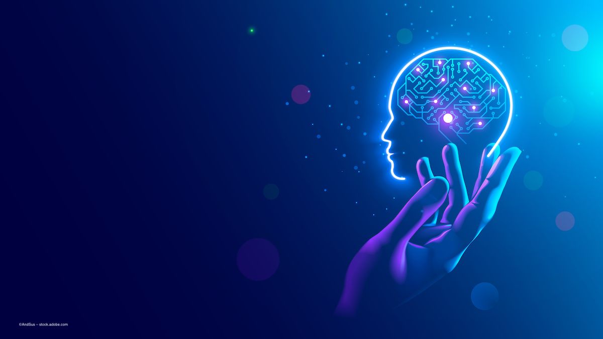 A hand and an icon of a brain with a computer chip in it, on a blue background. Image credit: ©AndSus – stock.adobe.com