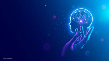 A hand and an icon of a brain with a computer chip in it, on a blue background. Image credit: ©AndSus – stock.adobe.com