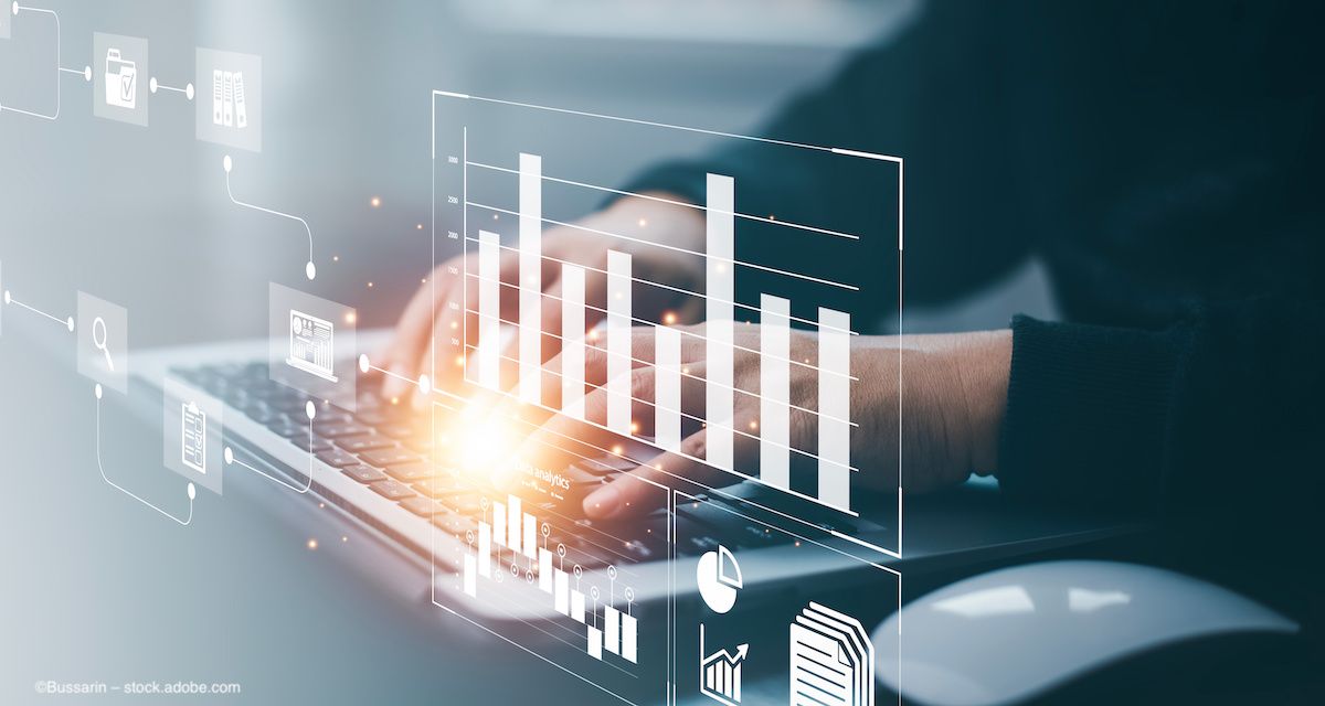 A person types on their computer while a digital overlay of data hovers over their hands. Image credit: ©Bussarin – stock.adobe.com