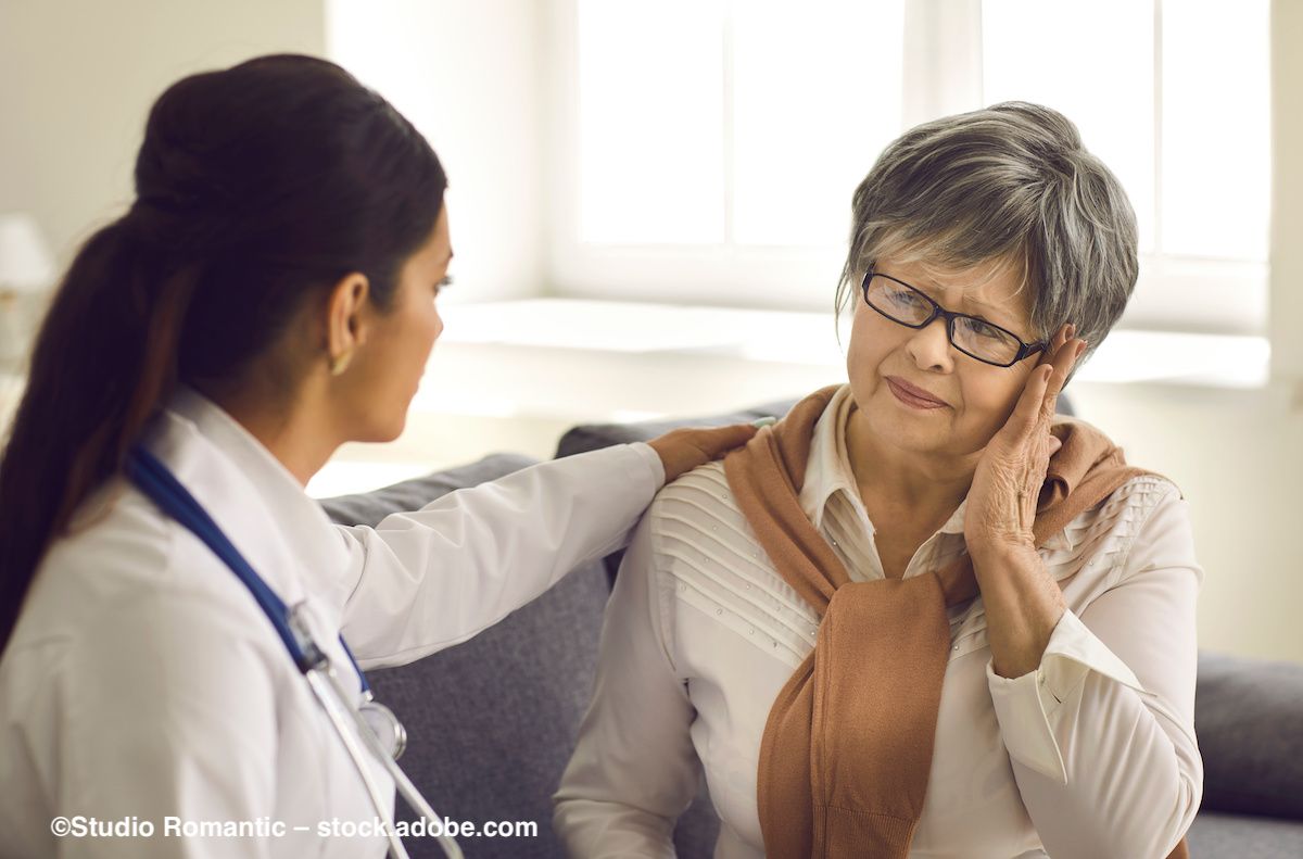 A doctor helps a patient with her glasses. Image credit: ©Studio Romantic – stock.adobe.com