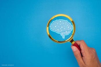 An illustration of a brain beneath a magnifying glass. Concept image for neuroophthalmological exam and ocular symptom paediatric neurology concept. Image credit: ©meeboonstudio – stock.adobe.com