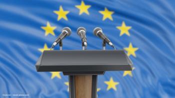 A lectern and podium, with three microphones, in front of the European Union (EU) flag. Concept image for Ophthalmology Times Europe editorial advisory board members presenting at American Academy of Ophthalmology meeting 2025. Image credit: ©corund – stock.adobe.com
