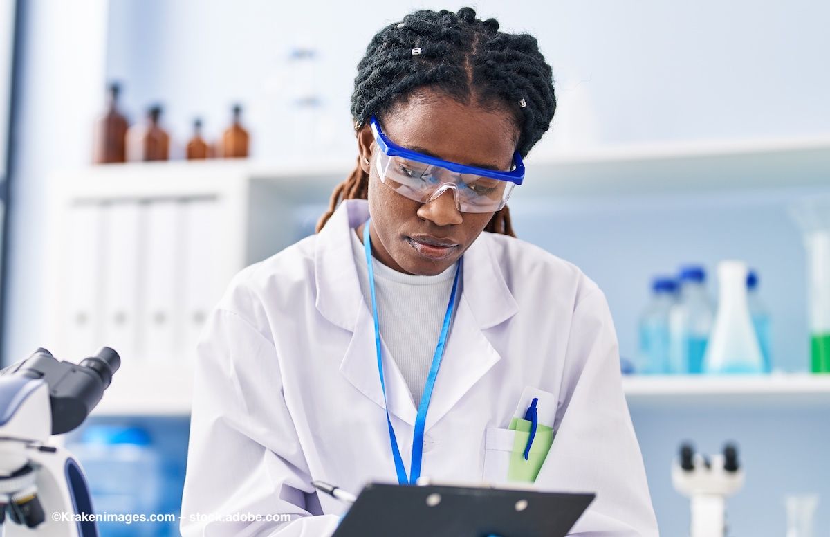 A scientist consults a clipboard. Image credit: ©Krakenimages.com – stock.adobe.com