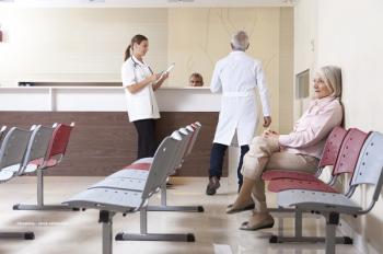 Patients check in at a doctor's office waiting room. Image credit: ©jovannig – stock.adobe.com