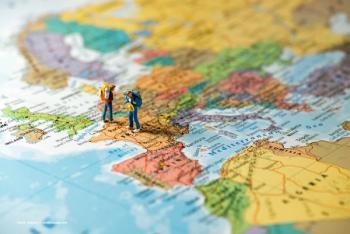 Miniature figures with backpacks stand on a map of Europe. Image credit: ©kirill_makarov – stock.adobe.com
