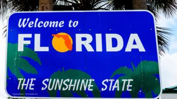 A sign in front of palm trees. It reads "Welcome to Florida: The Sunshine State." Concept image for American Academy of Ophthalmology 2025 meeting in Orlando, Florida. Image credit: ©quasarphotos – stock.adobe.com