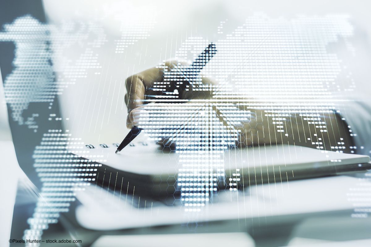 A digital map of the world, overlaid on top of a photo of a person writing with a pen in a notebook. Image credit: ©Pixels Hunter – stock.adobe.com