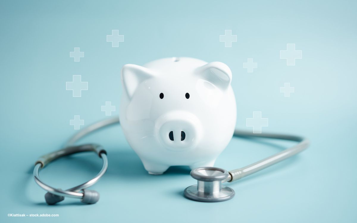 A white piggy bank sits near a stethoscope with first-aid crosses superimposed over the top.  Photo credit: ©Kiattisak – stock.adobe.com