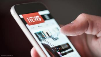 A smartphone with a news website visible on the screen. Concept image for business merger news, Adverum Biotechnologies and Eli Lilly merger, ophthalmic pharmaceutical business news. Image credit: ©terovesalainen – stock.adobe.com