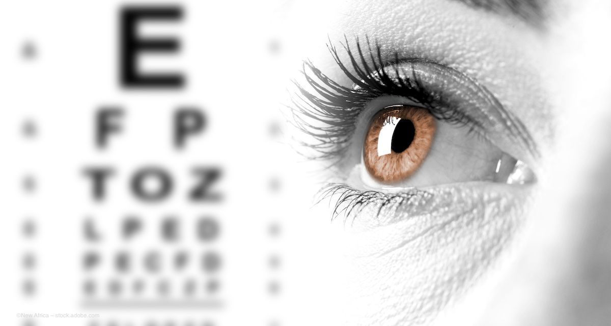 A close-up of an eye, with a brown iris and thick eyelashes. In the background is a Snellen visual acuity chart. Image credit: ©New Africa – stock.adobe.com