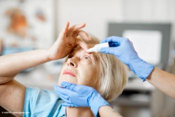A doctor's gloved hands administer eye drops in a female patient's eye. Image credit: ©rh2010 – stock.adobe.com