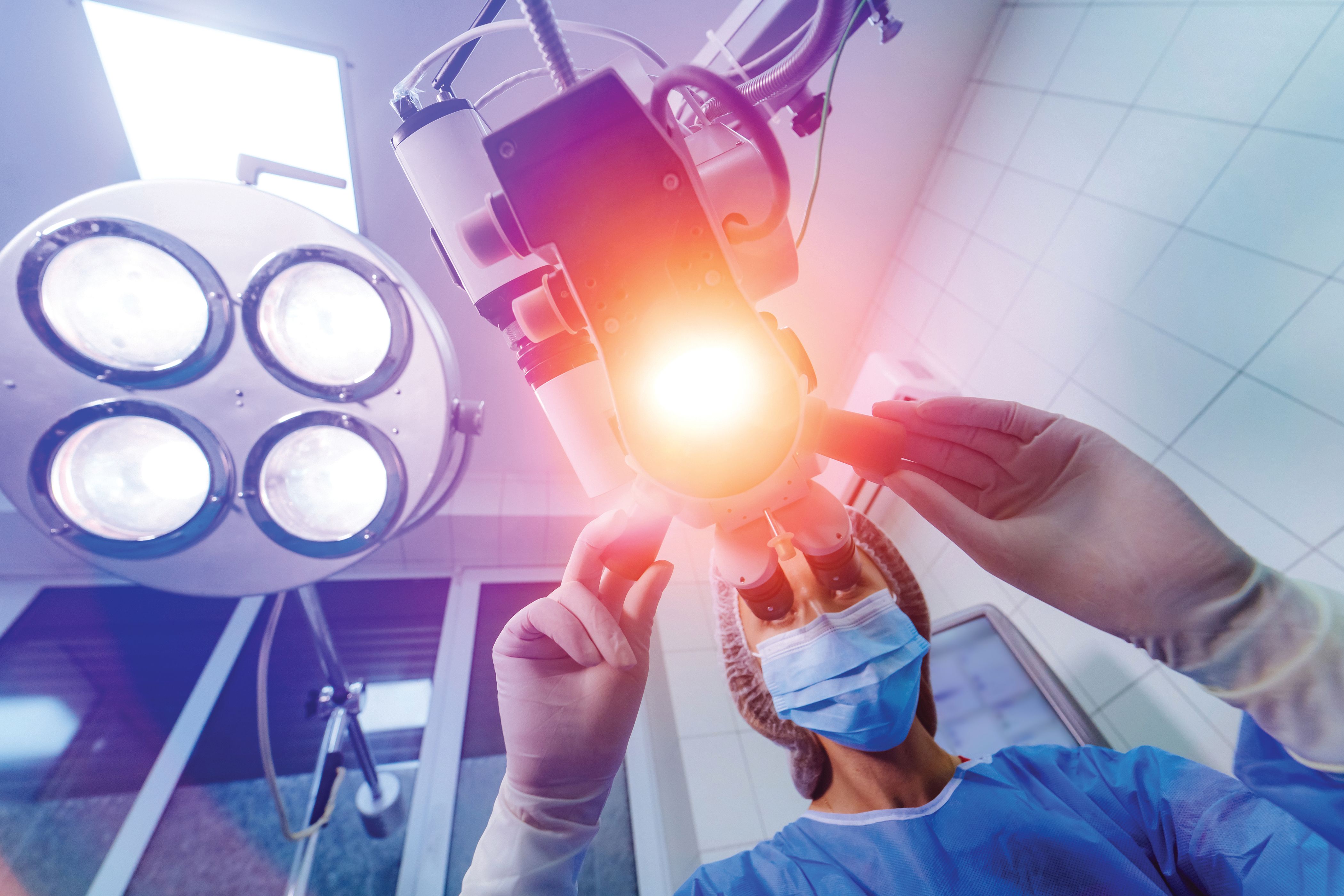 Ophthalmologist adjusting and aiming surgical lights