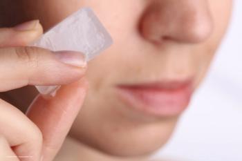 A woman holds an ice cube near her face. Concept image for chronic ocular surface pain treatment, EyeCool Therapeutics corneal cooling technology for dry eye disease. Image credit: ©dream@do – stock.adobe.com