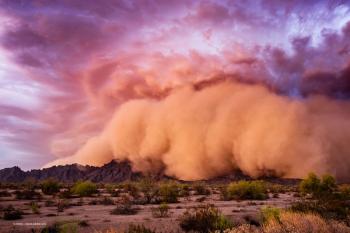 A haboob, or dust storm, moves over an arid desert landscape. Image credit: ©JSirlin – stock.adobe.com