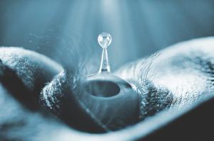 drop of liquid coming in contact with open eye