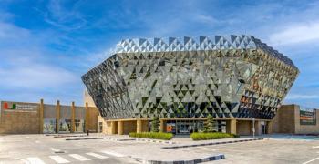 A photo of the Bascom Palmer Eye Institute in Abu Dhabi, which features faceted silver glass covering the 70,000 square foot ambulatory care centre. Image courtesy of UHealth – University of Miami Health System.