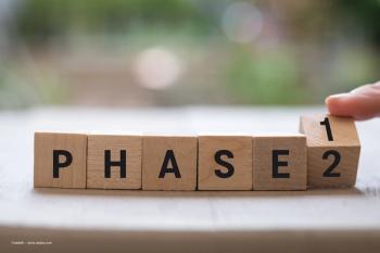 Wooden blocks which say PHASE and a block at the end with the numbers 1/2. The last block is switching from 1 to 2. This represents a clinical trial moving through phases. Image credit: ©rabbitti – stock.adobe.com