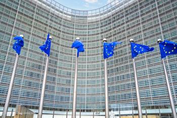 The European Commission building in Brussels, Belgium, with EU flags on view out front. Concept image for EC pharmaceutical ophthalmic drug approval. Image credit: ©xbrchx – stock.adobe.com