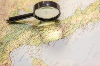 A map of Italy with a magnifying glass resting atop it. Image credit: ©sharafmaksumov – stock.adobe.com