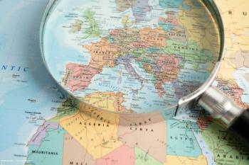 A map or globe, with Europe emphasised under a magnifying glass. Concept image for European launch of Johnson and Johnson presbyopia-correcting Tecnis Odyssey IOL. Image credit: ©Pakawadee – stock.adobe.com