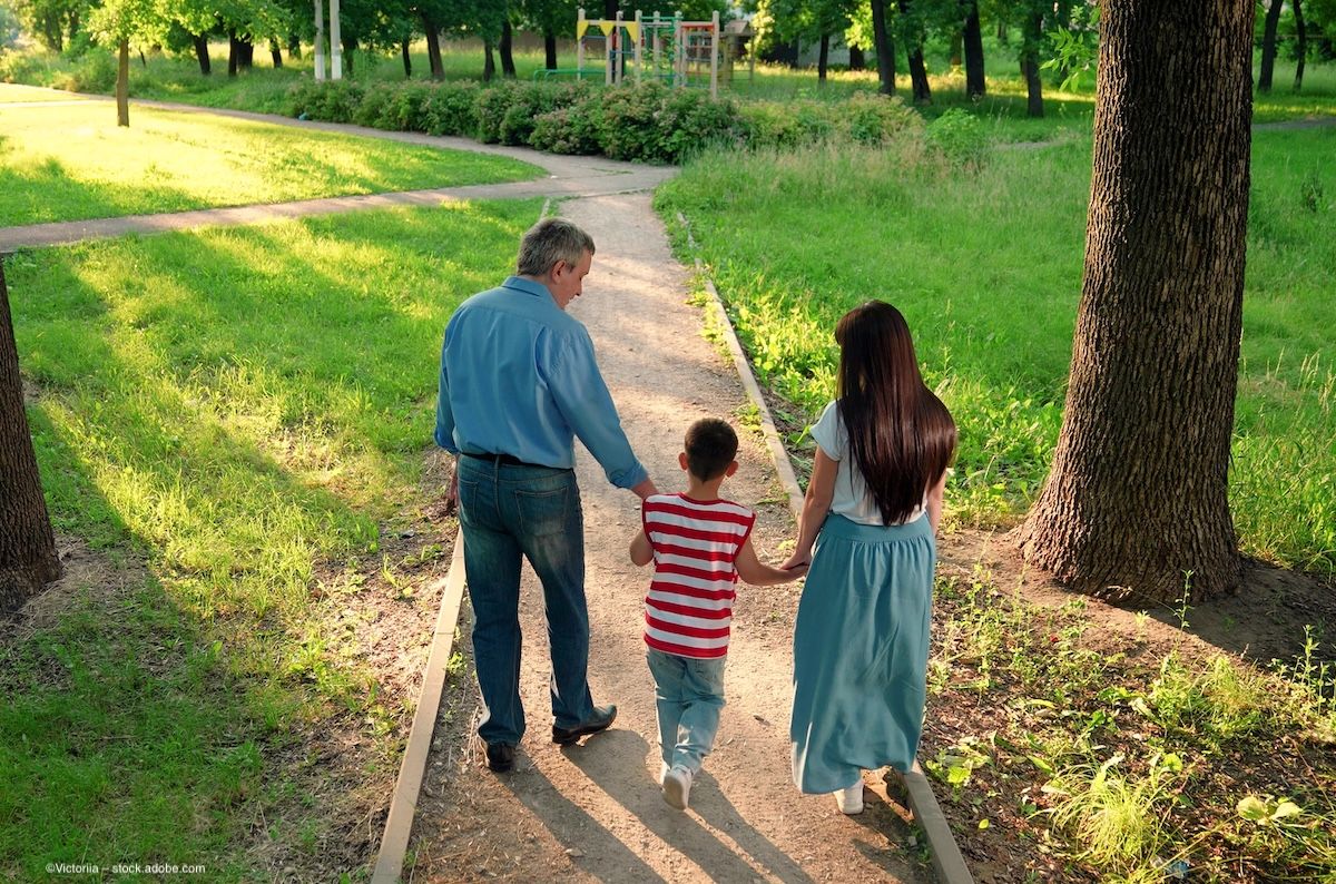 A family, two parents or grandparents and a child, walk outside in a park. Concept image for urban exposure to green space, dry eye disease, dry eye prevention, tear meniscus and ocular health. Image credit: ©Victoriia – stock.adobe.com