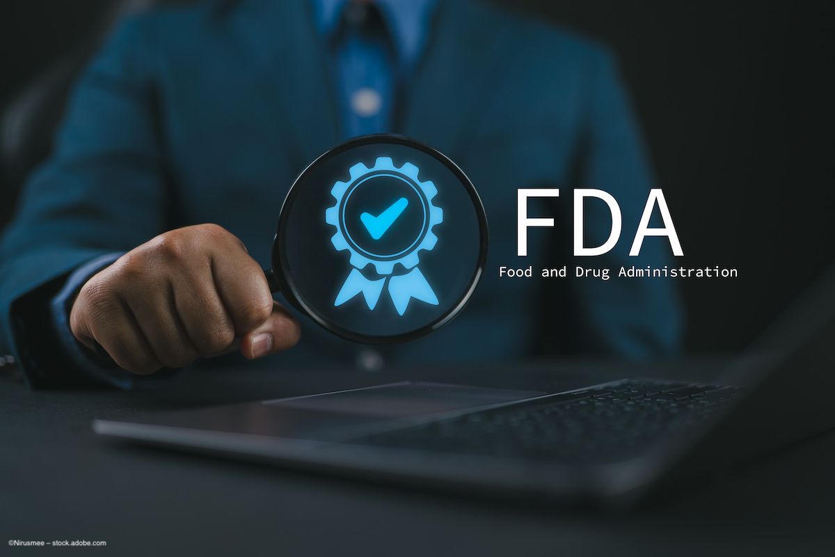 A person in a suit sits at a laptop. A US Food and Drug Administration logo and approval badge are superimposed over the image. Image credit: ©Nirusmee – stock.adobe.com