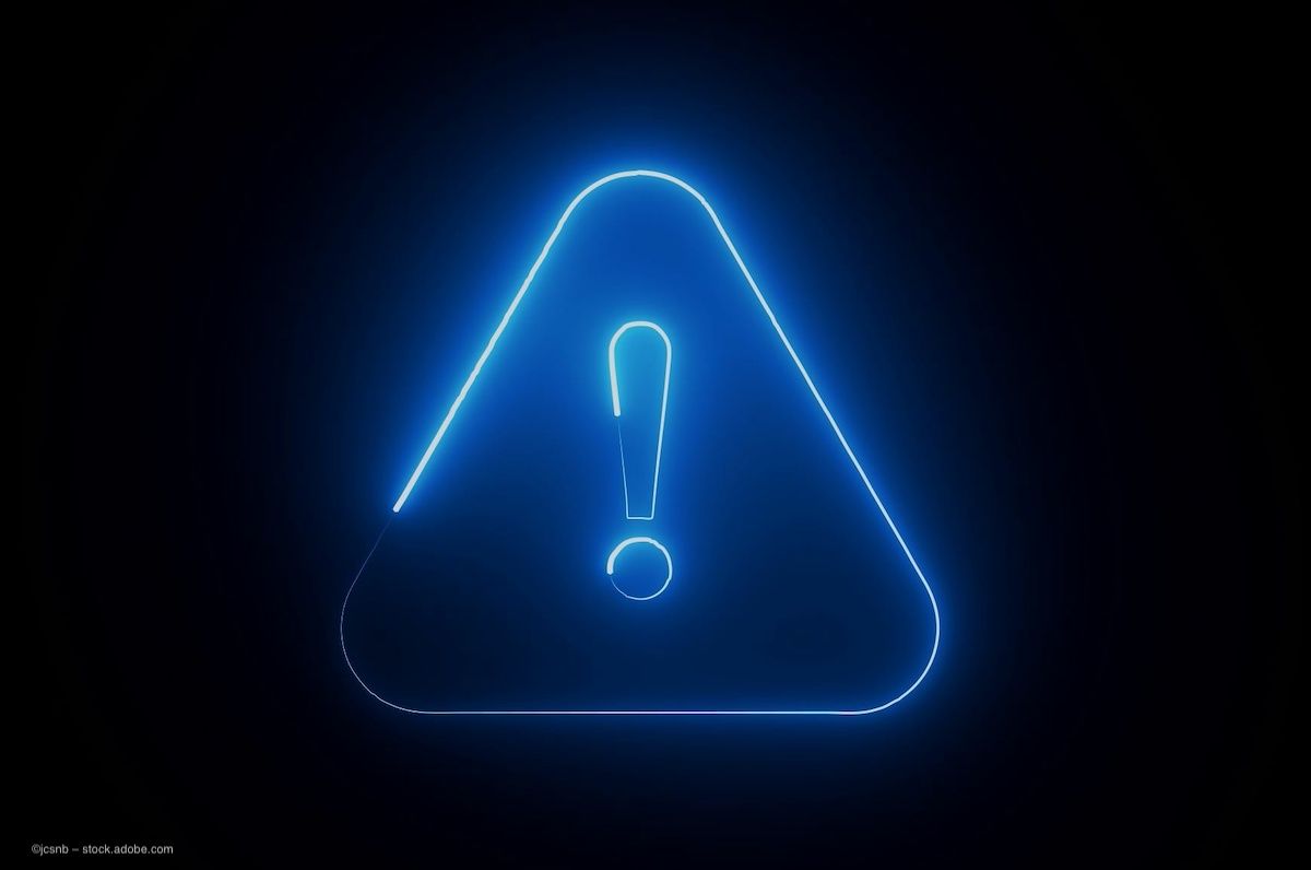 A blue hazard sign, an exclamation point (!) inside a triangle, to communicate the risks of misdiagnosing geographic atrophy and age-related macular degeneration. Image credit: ©jcsnb – stock.adobe.com