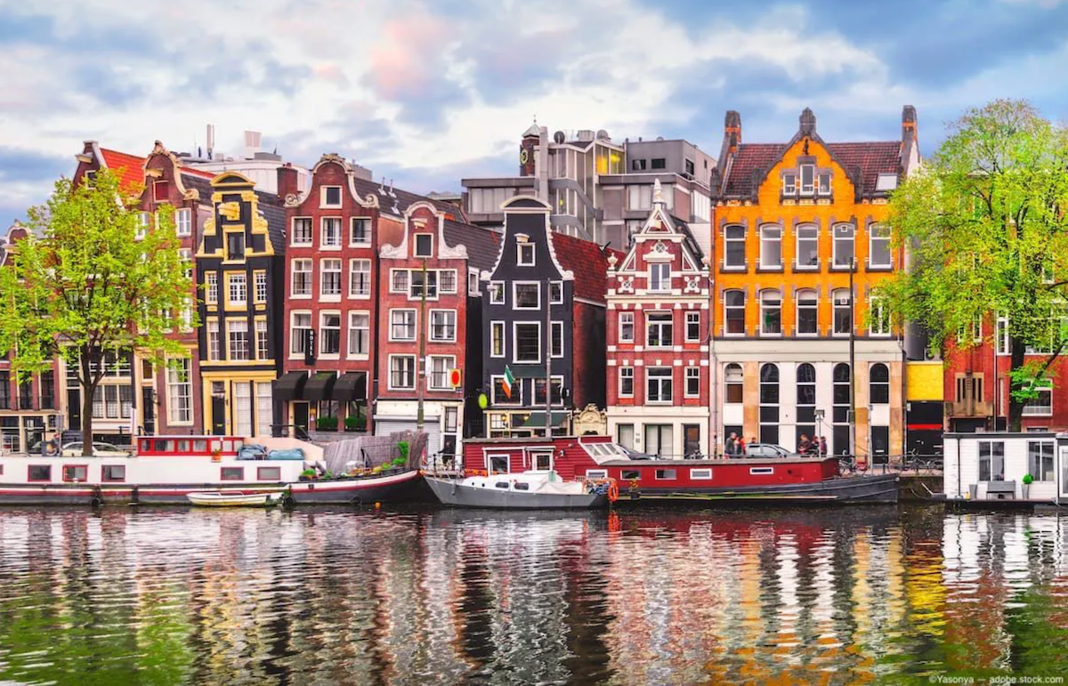 A row of houses in historic Amsterdam. Image Credit: ©Yasonya – stock.adobe.com