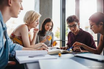 Diverse group of students studying at library (Adobe Stock / Jacob Lund)