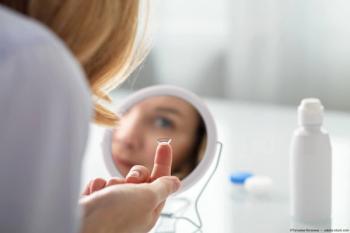 Woman putting on contact lens in mirror Image credit: ©Татьяна Кочкина - adobe.stock.com