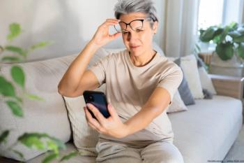 Woman taking off glasses to read phone Image credit: AdobeStock/kostikovanata