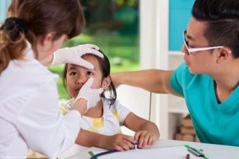 Physician examining child's eye Image credit: AdobeStock/Photographee.eu