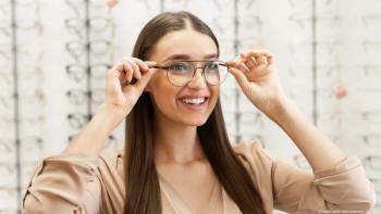 girl tries on frames in an optometry office