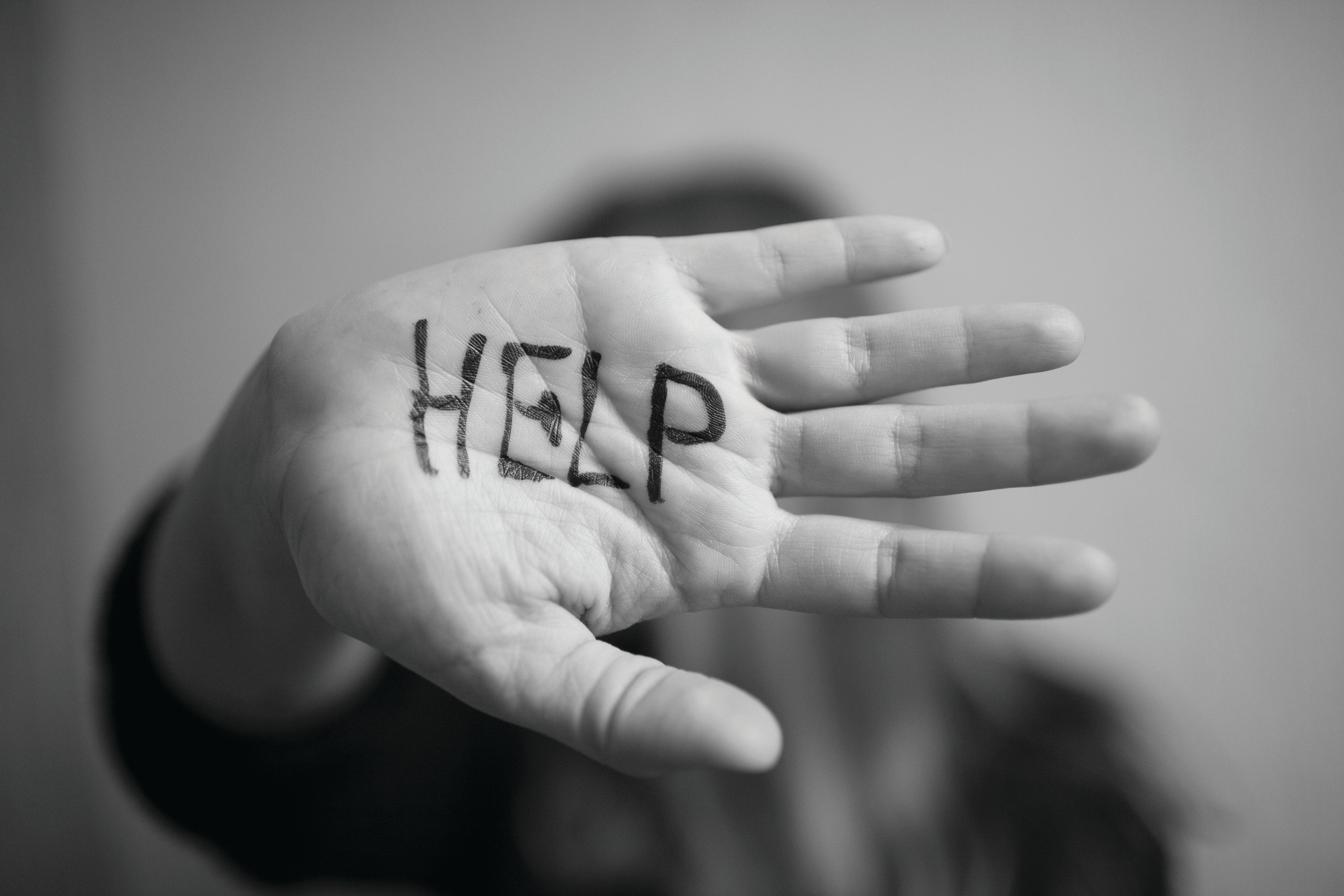 "Help" written on palm of hand Image credit: AdobeStock/Serghei