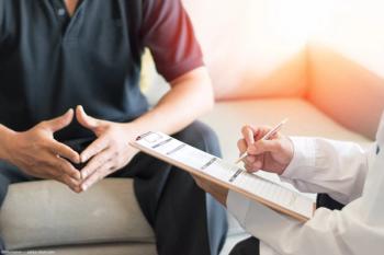 Patient and doctor discussing diagnosis Image credit: AdobeStock/Khunatorn
