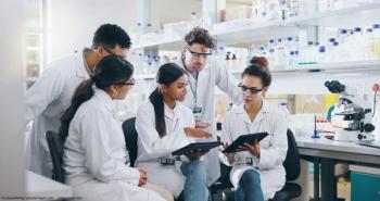 Scientists sitting in lab examining results Image credit: AdobeStock/CoetzeeRising/peopleimages.com