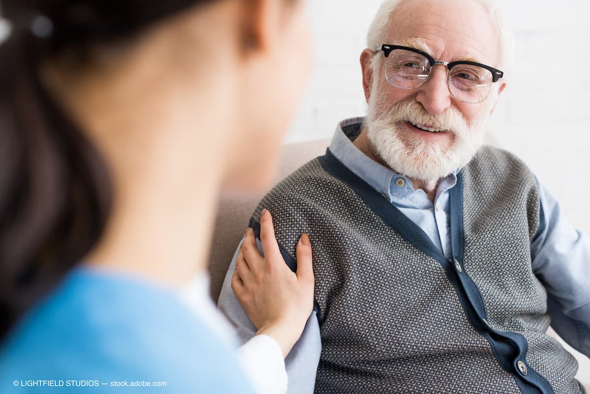 Selective focus of happy grey haired man looking at nurse (Adobe Stock / LIGHTFIELD STUDIOS)