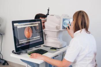 Physician taking retinal imaging of patient Image credit: AdobeStock/cherryandbees