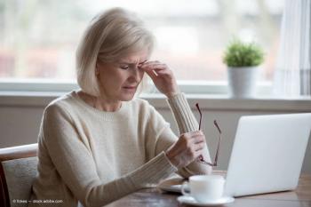 Older woman at computer desk rubbing eyes Image credit: ©fizkes - adobe.stock.com