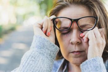 Woman with glasses rubbing her eyes outside Image credit: AdobeStock/madrolly