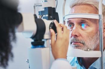 Man being administered a slit lamp exam Image credit: AdobeStock/ClementC/peopleimages.com