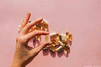 Pill being held between fingers Image credit: AdobeStock/DianaVyshniakova