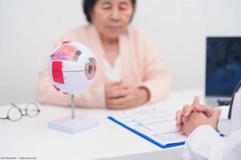Patient sitting at doctor's desk. Image credit: AdobeStock/JoPanuwatD