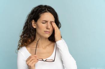 Woman with eye pain touching head Image credit: AdobeStock/DimaBerlin