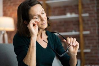 Woman rubbing eyes with glasses in hand Image credit: ©Andrey Popov - adobe.stock.com