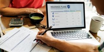 Two people at table reviewing insurance paperwork Image credit: ©Rawpixel.com - adobe.stock.com